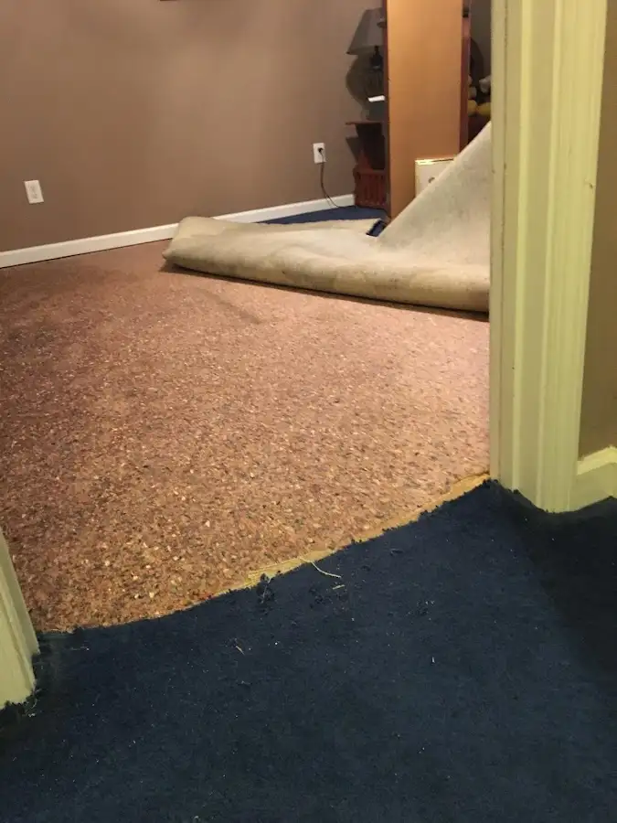 Carpet pad removal revealing water damage during Water Mitigation Services in Atascocita