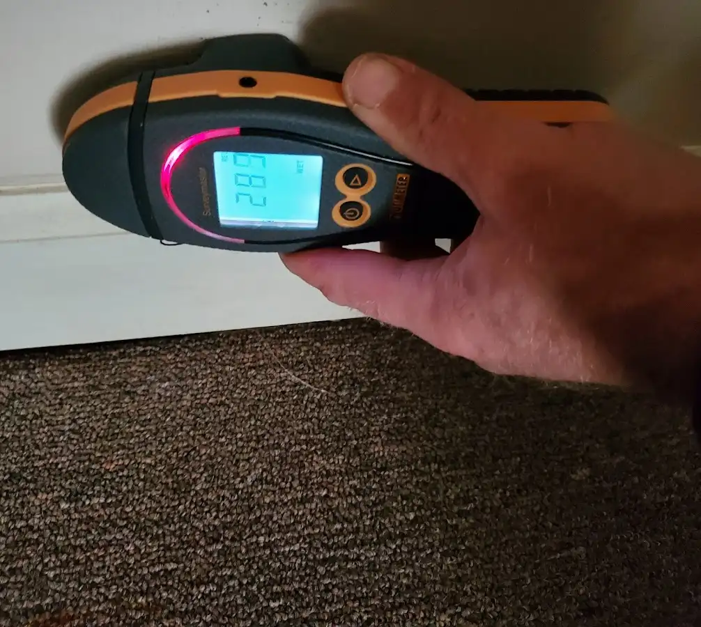Moisture detection at baseboard during Storm Damage Restoration in Atascocita